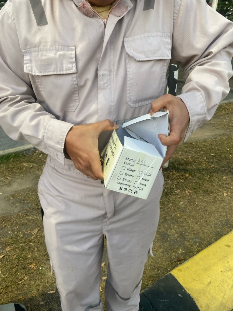 Customer receiving repaired smartphone at Port Klang